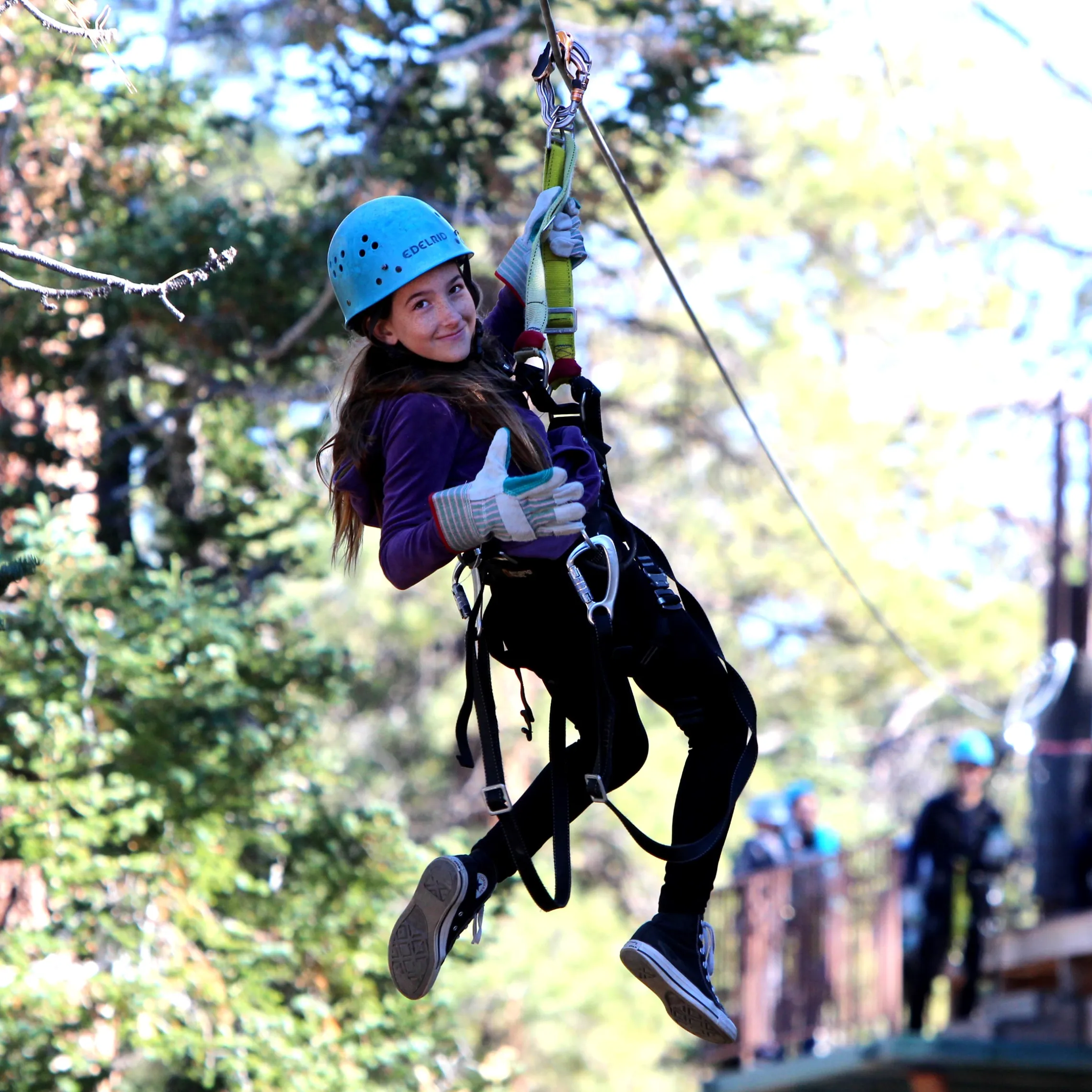 Small girl looking back while zip-lining