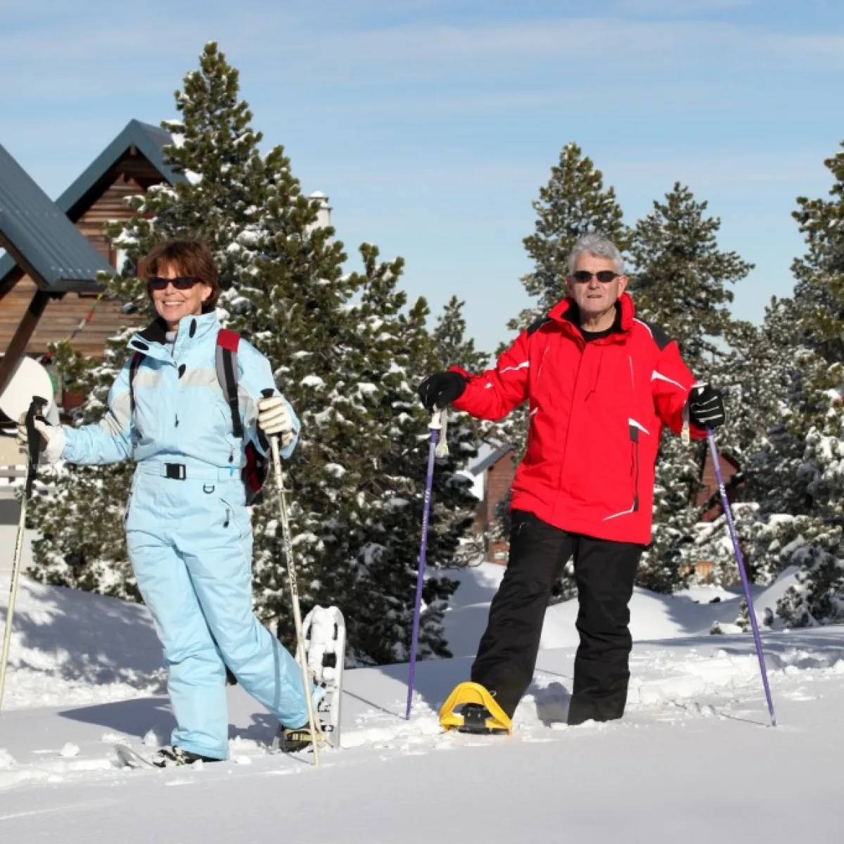 a group of people standing on top of a snow covered slope