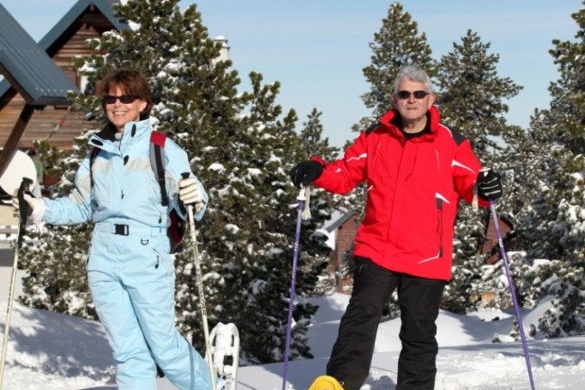 a group of people standing on top of a snow covered slope